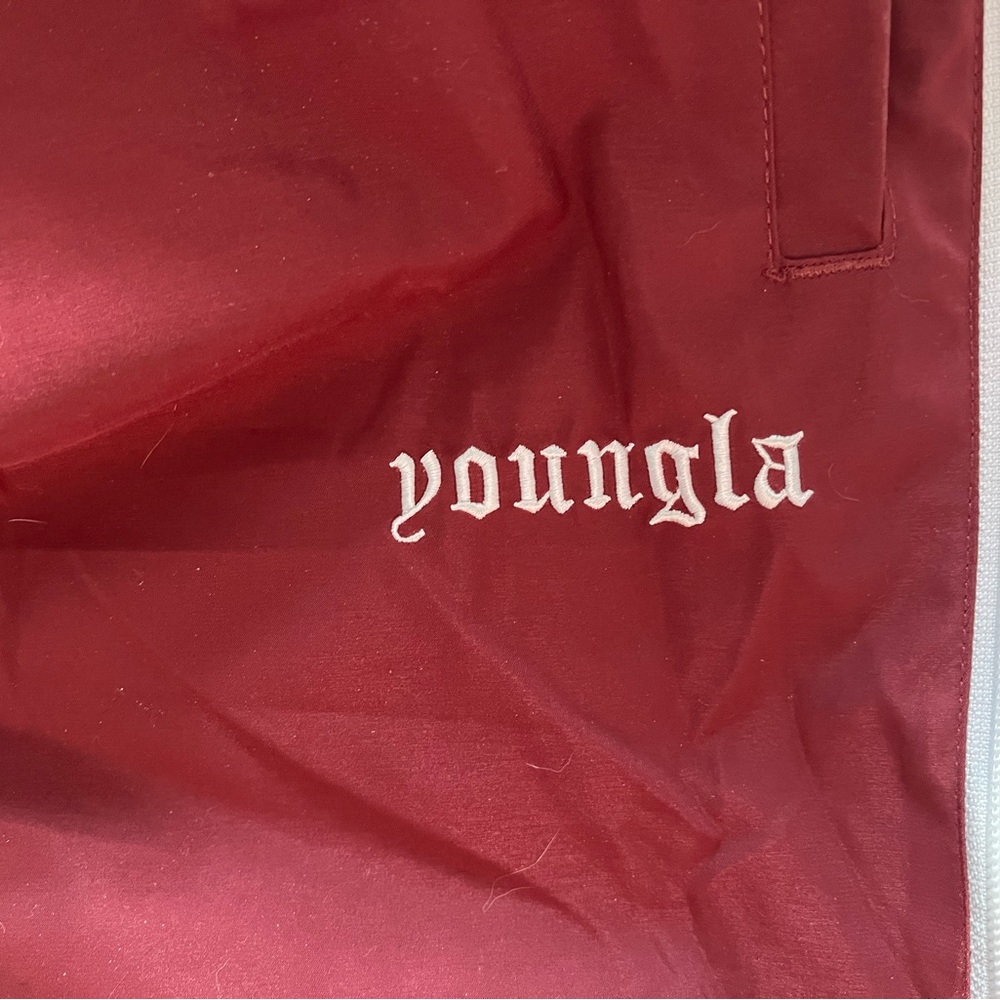 Pair of black and red young la side zipper joggers